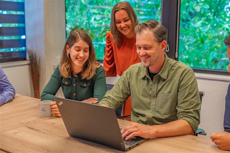 Group of people behind a laptop at AmeXio Group